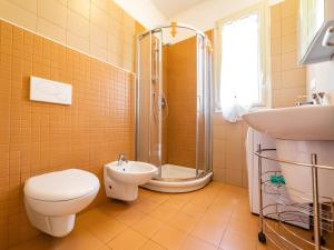 a bathroom with a toilet and a sink and a shower at Arco del Mare - swimming pool with nice sea view in Civezza