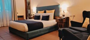 Postel nebo postele na pokoji v ubytování Corsaro Etna Hotel&SPA