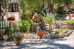 a bike parked in a garden with flowers at Anneta Studios in Syvota