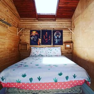 a bed in a room with paintings on the wall at Mylasa Farm and Villas in Muğla