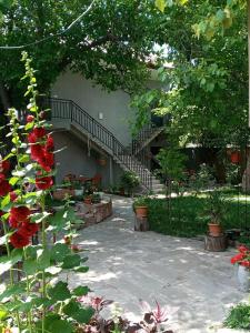 a garden with a staircase and some flowers at Hotel Beni in Akhaltsikhe