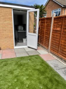 an open door in a house with a yard at Adorable Guest house in Erith
