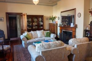 a living room with two couches and a fireplace at Victoria House in Portland