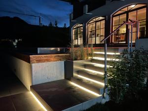 a set of stairs in front of a house with lights at Appartements Casa Nuova in Saalbach-Hinterglemm