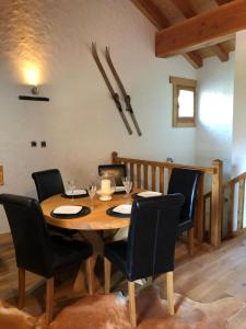 a dining room with a wooden table and chairs at Chalet Rose in Saint-Martin-de-Belleville