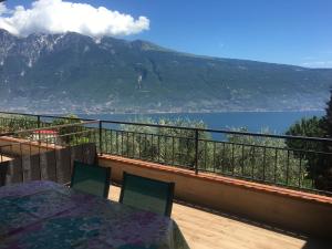 einen Balkon mit einem Tisch und Bergblick in der Unterkunft Ferienwohnung Oleandro mit Panorama in Tignale am Gardasee in Tignale