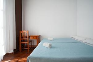 a bedroom with a bed and a chair at Residencia Universitaria San José in Málaga