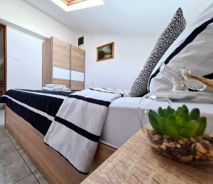 sypialnia z łóżkiem i stołem z rośliną w obiekcie Apartments Ana Medulin w Medulinie
