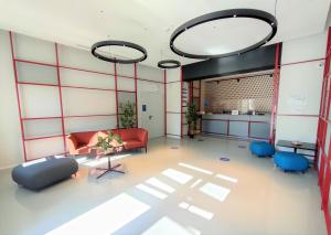 a living room with a red couch and blue chairs at Camplus Bernini Casa per Ferie in Turin