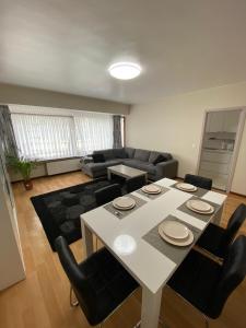 a living room with a table and a couch at Haik's Palace in Ostend