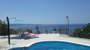 a swimming pool with a view of the water at Villa Blue View in Sumpetar