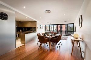 a kitchen and dining room with a table and chairs at Sub Penthouse Luxe suit, CBD, secure parking, in Hobart