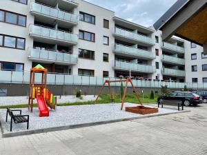 a playground in front of a apartment building at Apartament Camilli Lackberg in Jelenia Góra