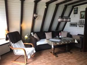 a living room with a couch and a table at Domek letniskowy Julia in Ińsko