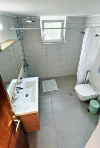 a bathroom with a sink and a toilet at Casa di Sole in Nikiana +3 photos