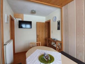 a small room with a table and a tv on the wall at Bauernhof Neu-Endfelden, Günter Widauer in Söll