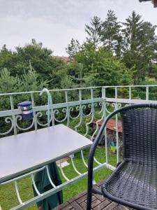 a table and a chair on a balcony at Azalka Penzion in Brno