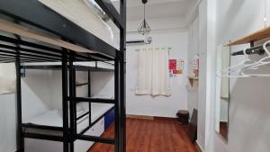 a room with two bunk beds and a hallway at HOSHTEL99 - PRIME - Stay, Cowork & Connect in Pune
