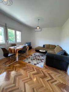 a living room with a couch and a table at Entire 1-bedroom apartment with free parking in Podgorica