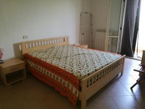 a bedroom with a bed with a wooden frame at Casa Vacanza Libone in Nova Siri Marina