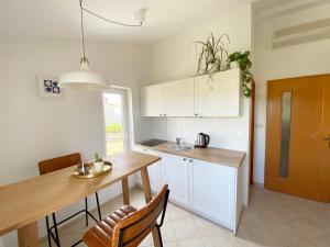 a kitchen with a table and a dining room at Apartments Mester in Sveti Anton