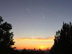 um pôr-do-sol com um avião a voar no céu em B&B Il Sentiero dei Goti em Monte Grimano Terme