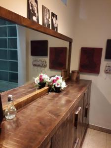 a wooden counter with flowers on it in a room at Lovely apartment premium location in Ramat Gan