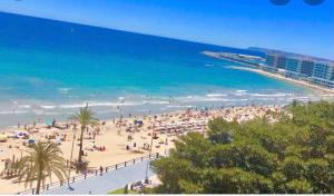 a beach with a lot of people and the ocean at 15 Rafael Altamira Apartmento 2 minutes from sea in Alicante