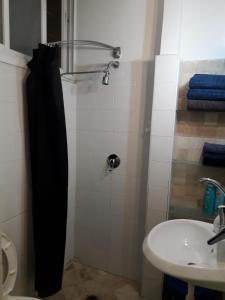 a bathroom with a shower and a sink at Lovely apartment premium location in Ramat Gan +25 photos