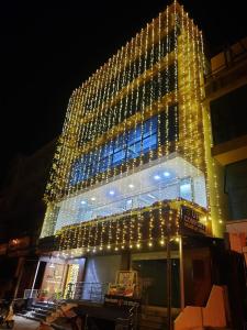 a large building with christmas lights on it at Hotel UR Comforts Jayanagar in Bangalore