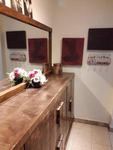 a room with a wooden counter with flowers on it at Lovely apartment premium location in Ramat Gan