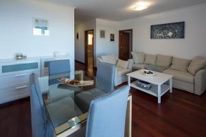 a living room with a couch and a table at Apartment Ocean Gardens in Caniço