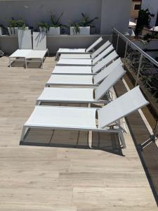 a row of white benches sitting on top of a building at Tenuta Micoli in Frisa