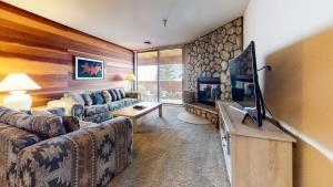 a living room with a couch and a tv at Bridges #105 Condo in Mammoth Lakes