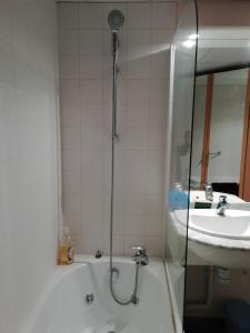 a bathroom with a shower and a sink at château de Locquéran Pierres et filets bleus in Plouhinec