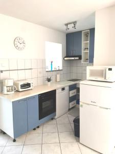 a kitchen with blue and white appliances and a clock at B&B Sveti Petar in Sveti Petar