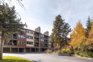 an apartment building with trees in front of it at Park Place 102C in Breckenridge