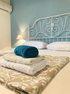 a pile of towels sitting on top of a bed at Kaala Old House Apartment in Supetarska Draga