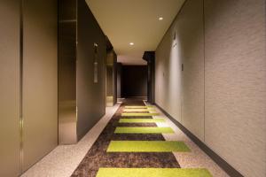 a hallway with green and yellow floors in a building at karaksa hotel TOKYO STATION in Tokyo