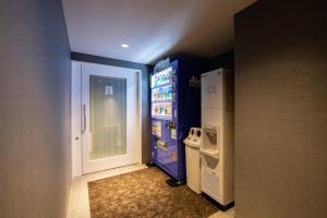 a room with a refrigerator and a water machine at karaksa hotel TOKYO STATION in Tokyo