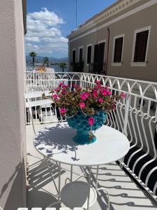 a vase of flowers sitting on a table on a balcony at L'Ancora B&B in Milazzo