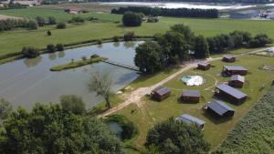 an aerial view of a farm with a lake at Studio Domaine du vieux chêne in Bergerac