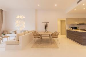 a living room and kitchen with a table and a couch at Tanoak Resort in Ain Sokhna