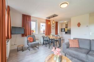 a living room with a couch and a table at Fleurie de Montagne in Mechelen