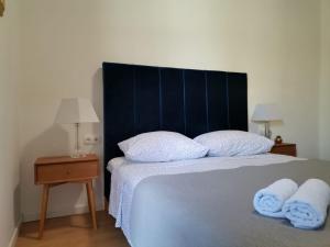 a bedroom with a bed with two towels on it at Luxury apartment Tamaris by the sea in Nin