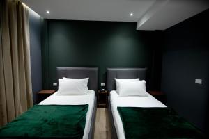 Postel nebo postele na pokoji v ubytování Mergan Hotel