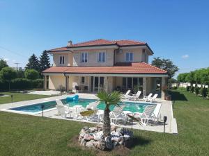 a villa with a swimming pool in front of a house at Vila Eleonora Beograd in Belgrade