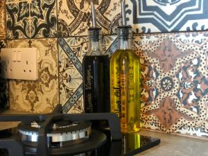 two bottles of wine sitting on top of a stove at Coral Cabins in Dunvegan