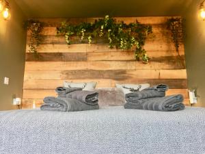 a bedroom with a bed with a wooden wall at Coral Cabins in Dunvegan