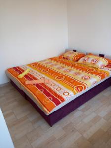 a bed sitting on a floor in a room at MD APARTMANI CANJ in Čanj